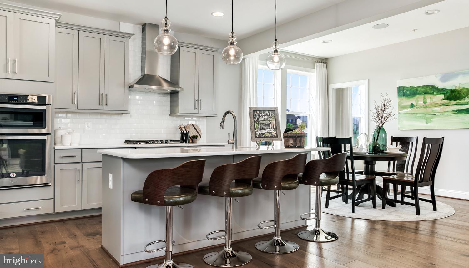 161 Silverleaf Drive Charles Town, WV 25414 - Photo 3 of 14 a kitchen with a table chairs stove and cabinets