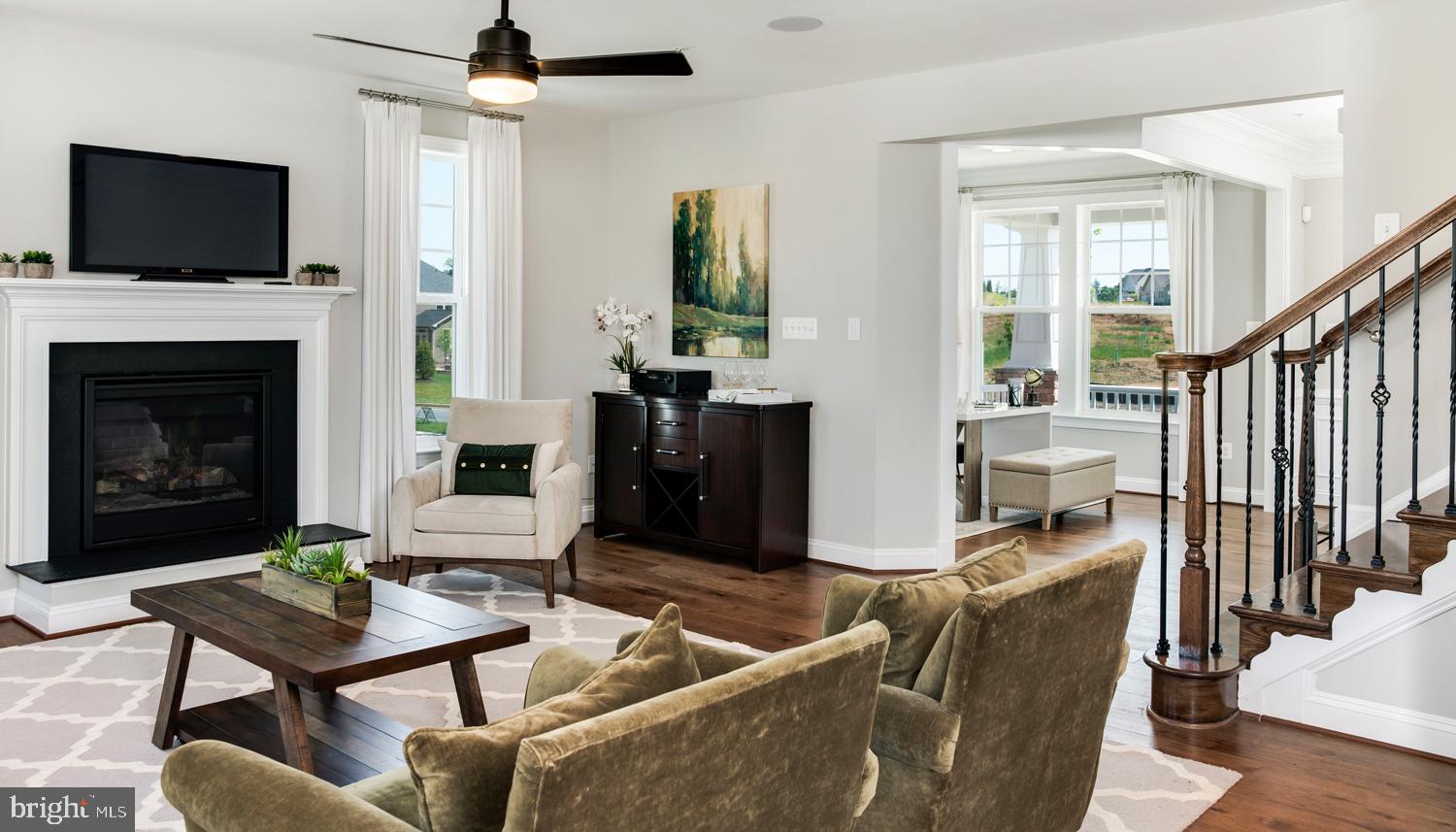 161 Silverleaf Drive Charles Town, WV 25414 - Photo 4 of 14 a living room with furniture a flat screen tv and a fireplace
