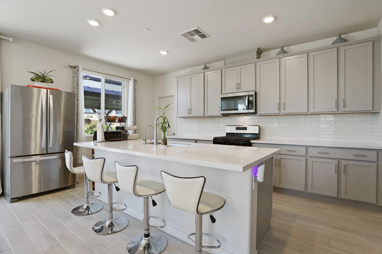 6949 Foraker Drive Stockton, CA 95219 - Photo 13 of 34 a kitchen with a refrigerator and a stove top oven