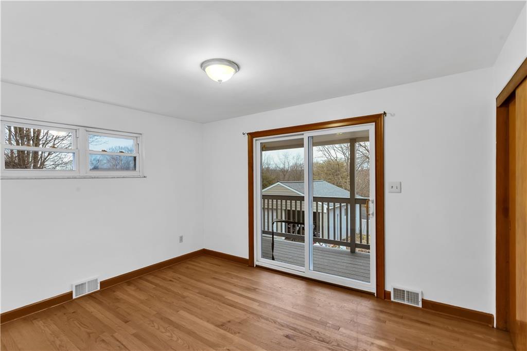 138 Sunset Lane Aliquippa, PA 15001 - Photo 11 of 31 a view of an empty room with wooden floor and a window