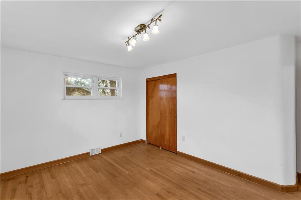 138 Sunset Lane Aliquippa, PA 15001 - Photo 16 of 31 a view of an empty room with wooden floor and a chandelier fan