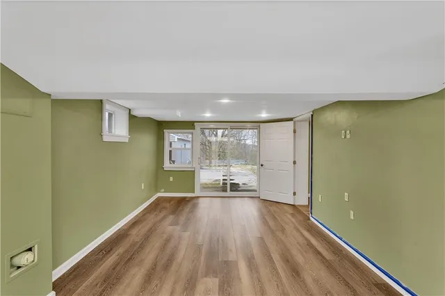 a view of a room with wooden floor and a window