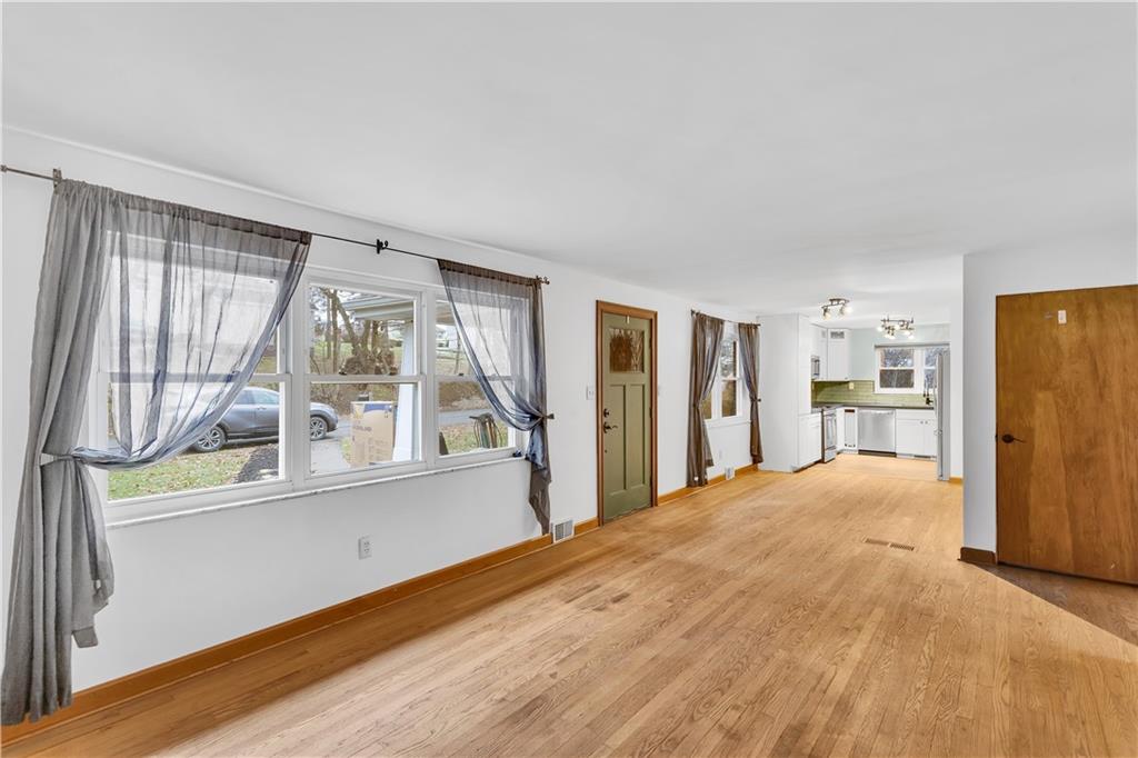 138 Sunset Lane Aliquippa, PA 15001 - Photo 2 of 31 a view of empty room with wooden floor and fan
