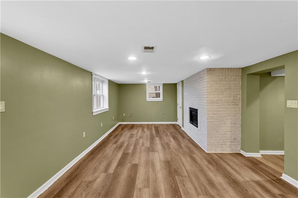 138 Sunset Lane Aliquippa, PA 15001 - Photo 22 of 31 a view of an empty room with wooden floor and a window