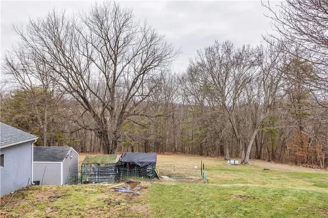 a backyard of a house with lots of green space and fountain