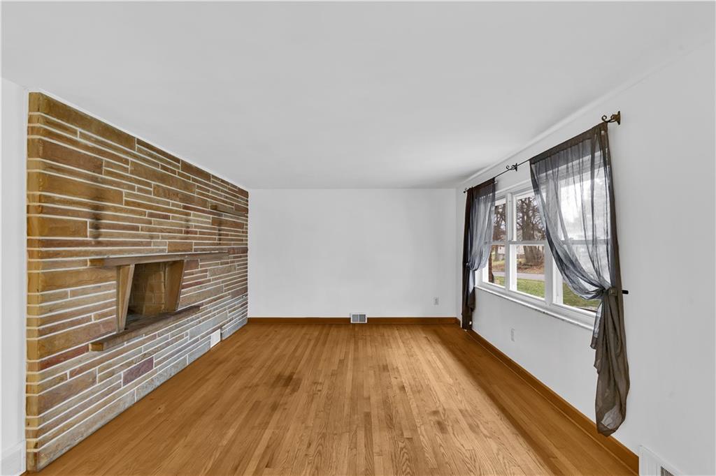 138 Sunset Lane Aliquippa, PA 15001 - Photo 3 of 31 a view of empty room with wooden floor and fan