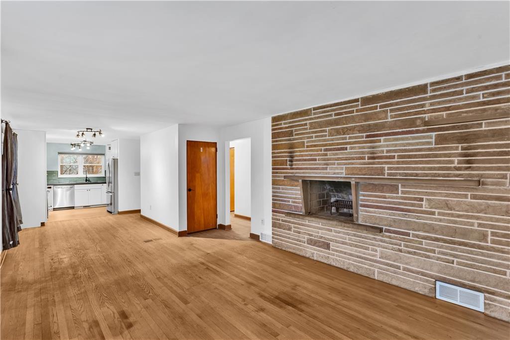 138 Sunset Lane Aliquippa, PA 15001 - Photo 5 of 31 a view of empty room with wooden floor and fireplace
