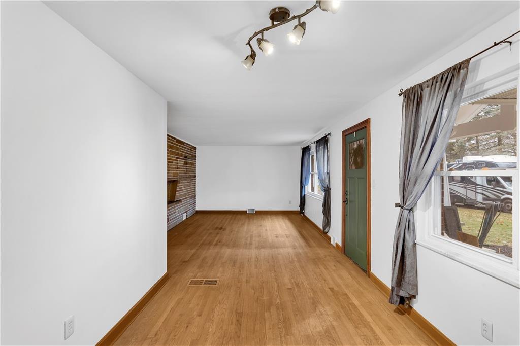 138 Sunset Lane Aliquippa, PA 15001 - Photo 7 of 31 a view of a hallway with wooden floor and staircase