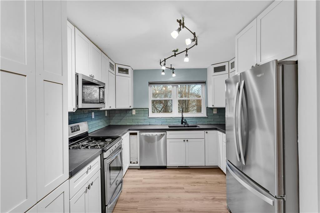 138 Sunset Lane Aliquippa, PA 15001 - Photo 8 of 31 a kitchen with stainless steel appliances a sink stove and refrigerator