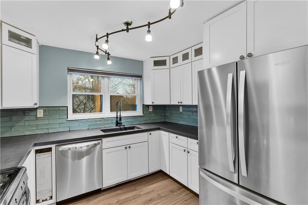 138 Sunset Lane Aliquippa, PA 15001 - Photo 9 of 31 a kitchen with a sink a refrigerator and window