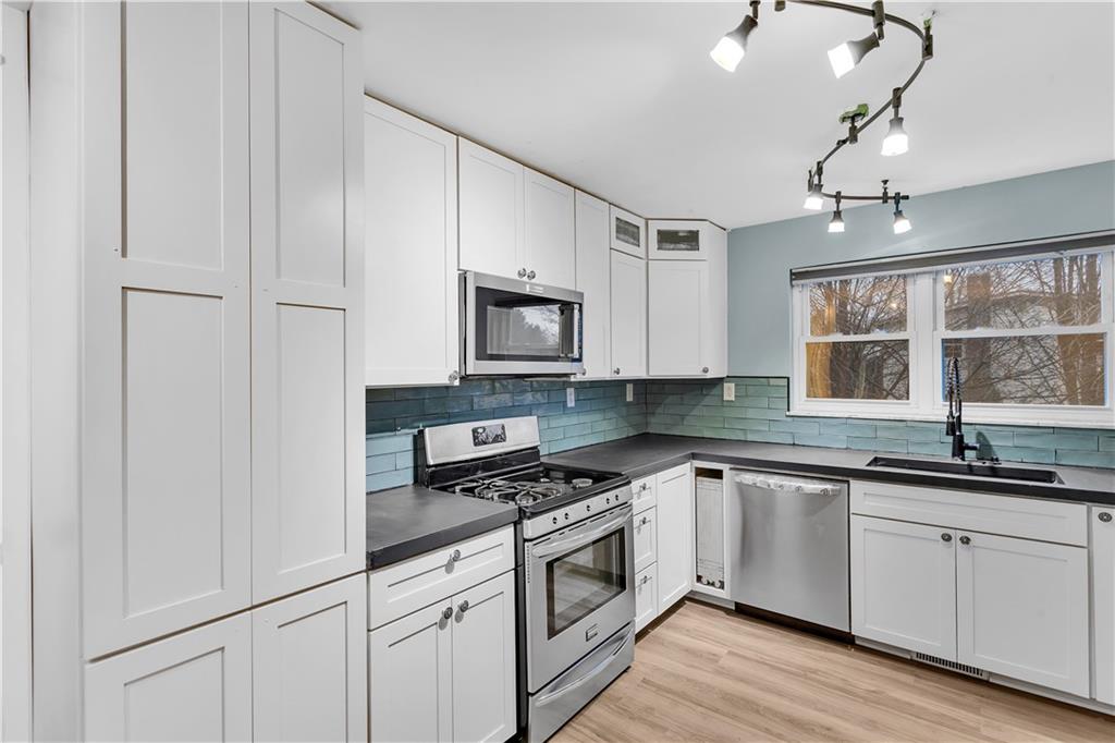 138 Sunset Lane Aliquippa, PA 15001 - Photo 10 of 31 a kitchen with white cabinets and appliances