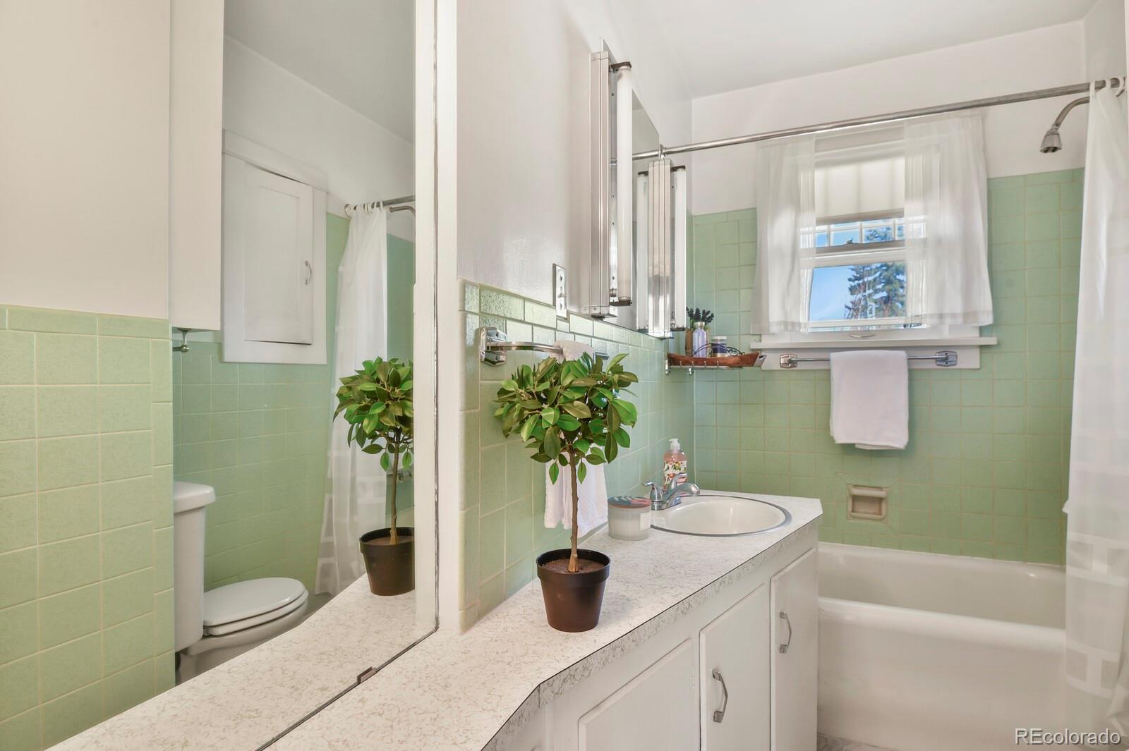 4537 Quitman Street Denver, CO 80212 - Photo 12 of 38 a bathroom with a sink a toilet and shower