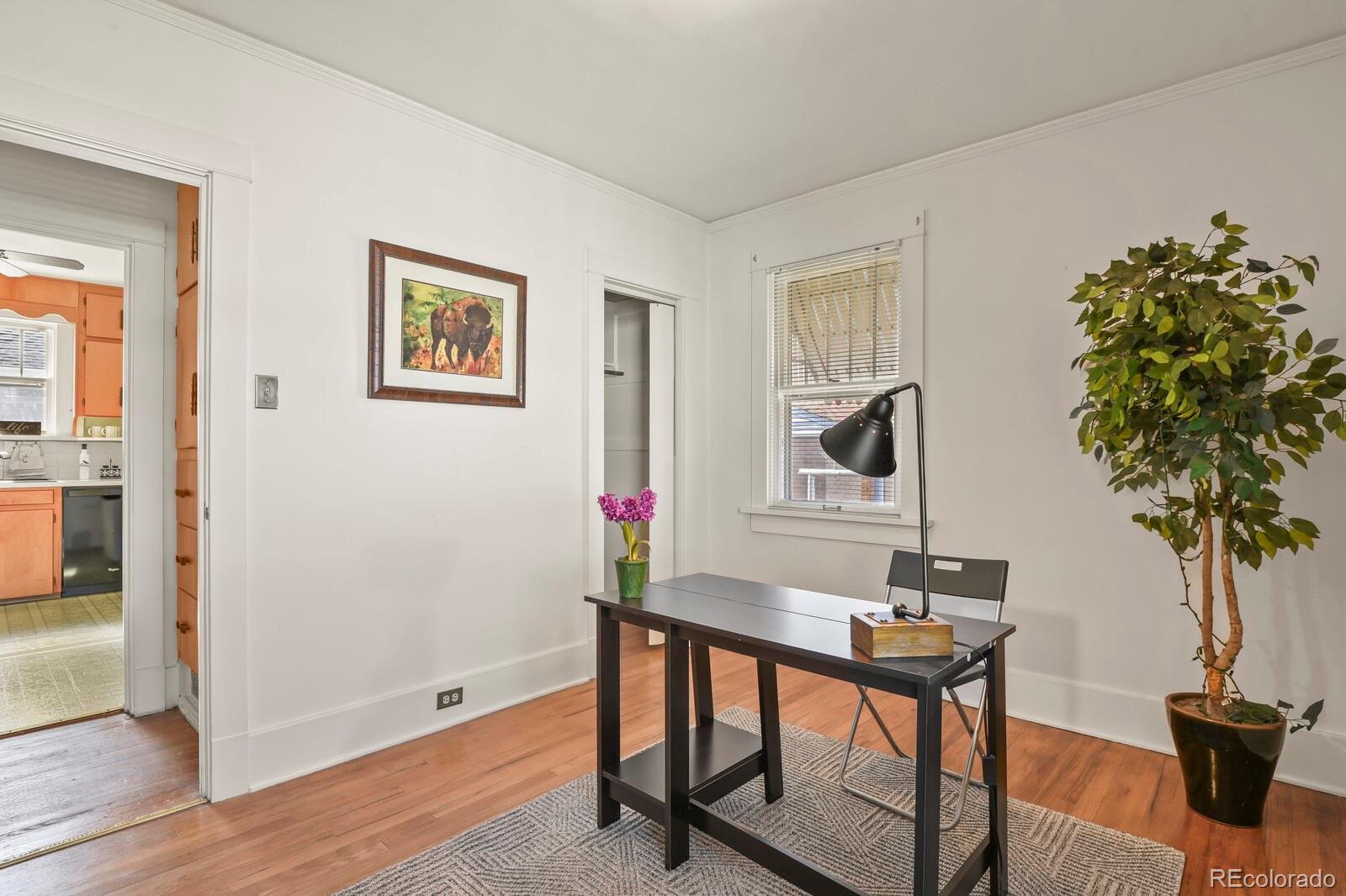 4537 Quitman Street Denver, CO 80212 - Photo 13 of 38 a view of a workspace room with wooden floor and table chair