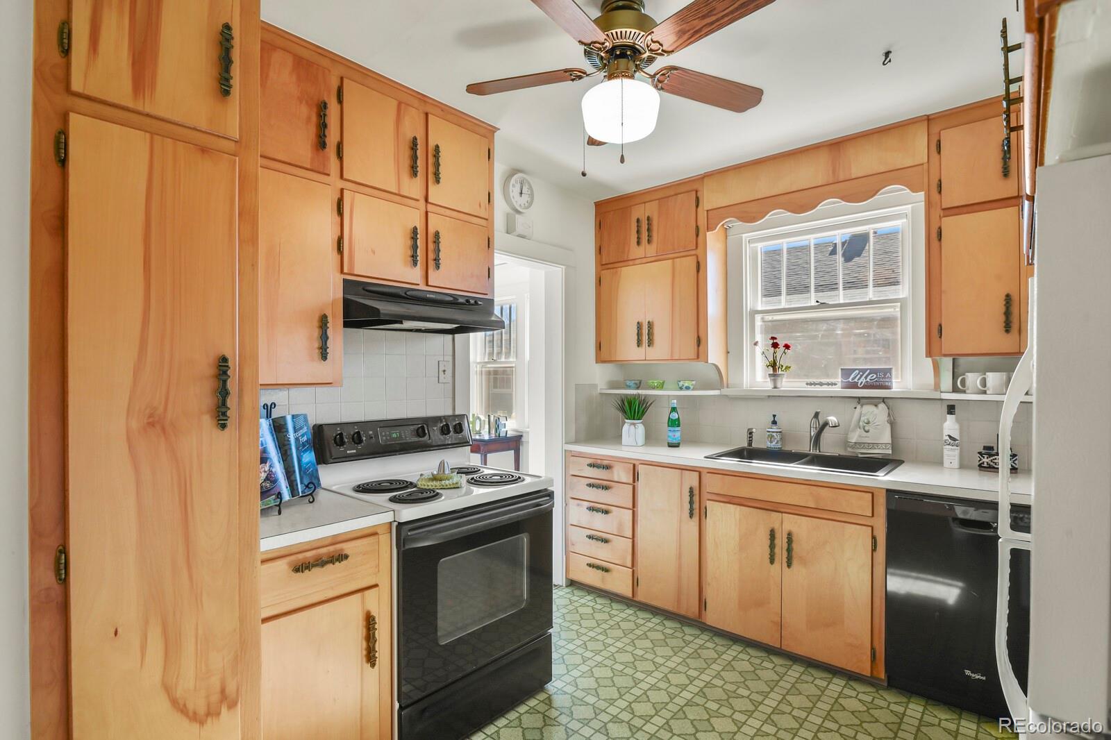 4537 Quitman Street Denver, CO 80212 - Photo 16 of 38 a kitchen with stainless steel appliances granite countertop a sink a stove and a refrigerator