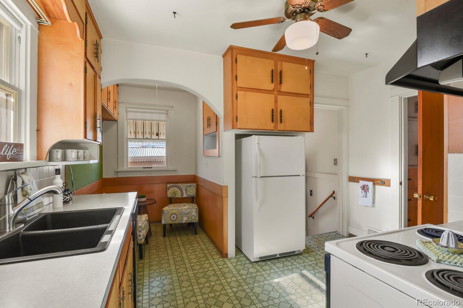 4537 Quitman Street Denver, CO 80212 - Photo 18 of 38 a kitchen that has a sink and a stove