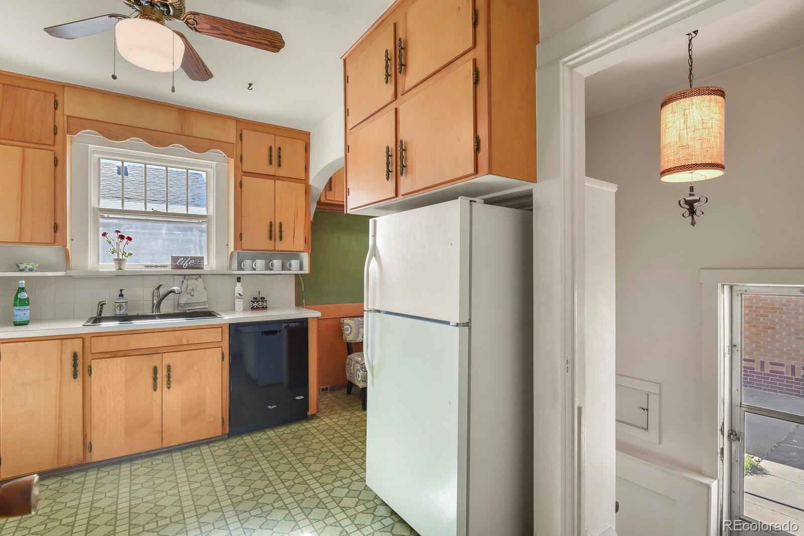 4537 Quitman Street Denver, CO 80212 - Photo 19 of 38 a kitchen with a refrigerator a sink and dishwasher with wooden floor