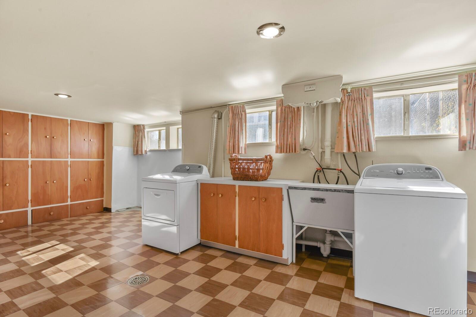 4537 Quitman Street Denver, CO 80212 - Photo 27 of 38 a room with a chair and white cabinets