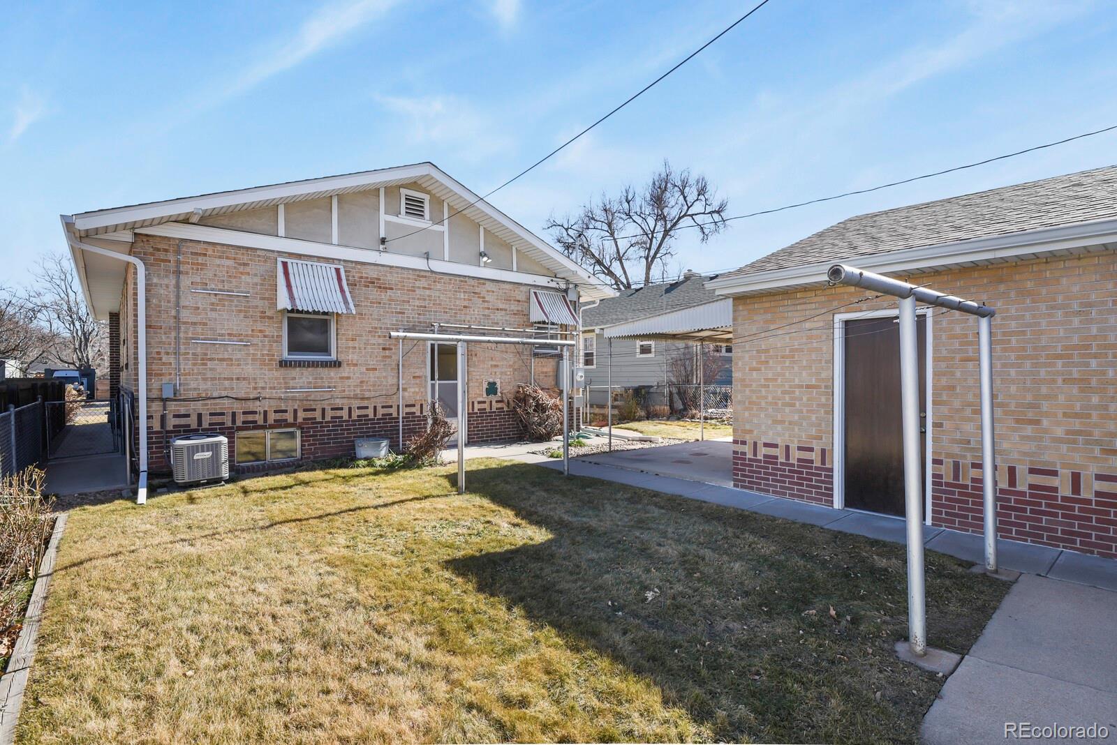 4537 Quitman Street Denver, CO 80212 - Photo 31 of 38 a view of a house with a patio and a yard