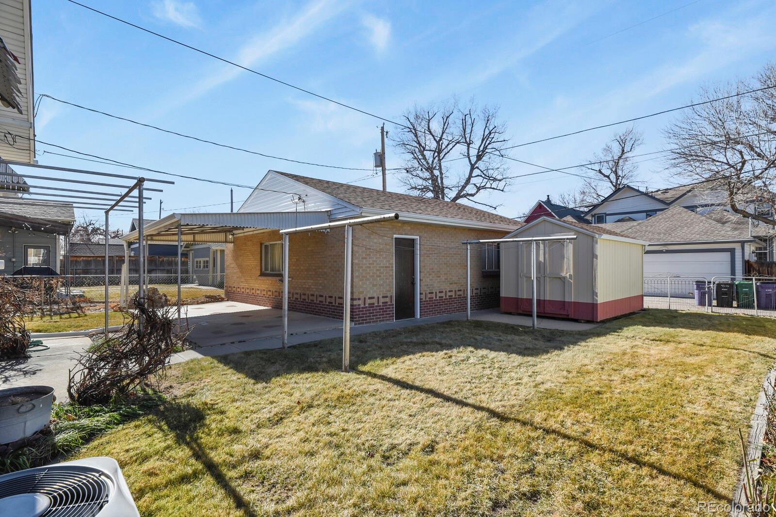 4537 Quitman Street Denver, CO 80212 - Photo 32 of 38 a front view of a house with a yard outdoor seating and garage