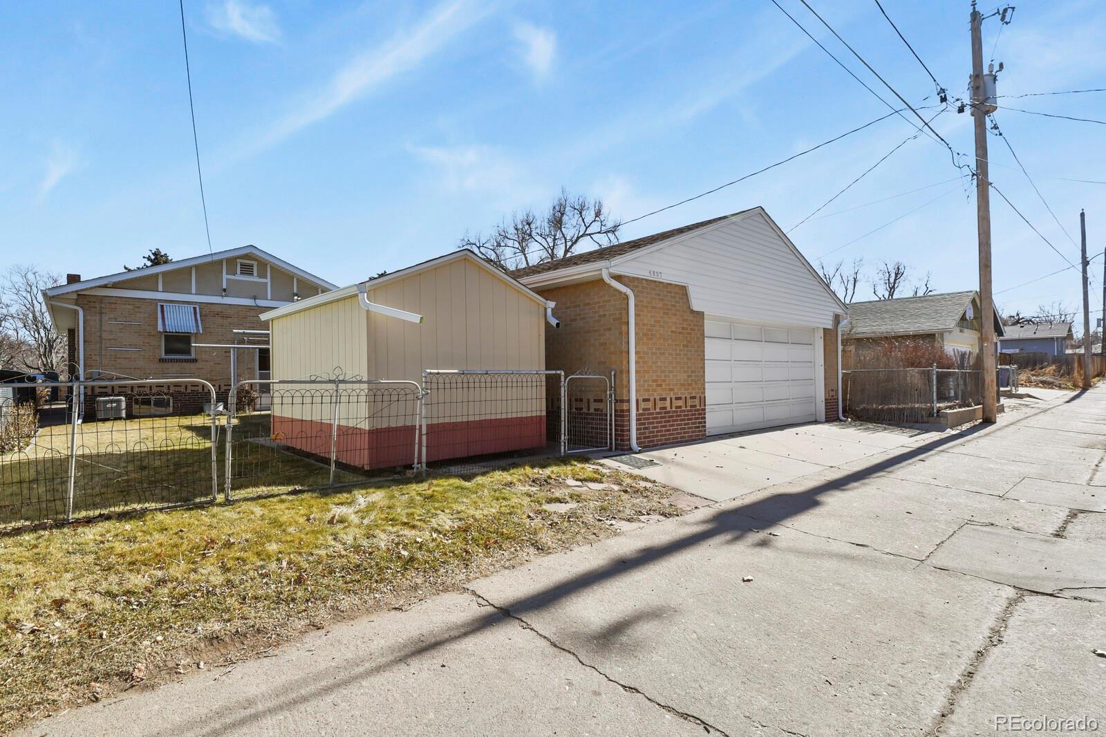 4537 Quitman Street Denver, CO 80212 - Photo 34 of 38 a view of a house with a small yard and wooden fence