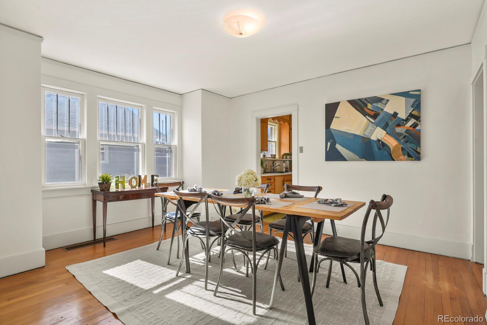 4537 Quitman Street Denver, CO 80212 - Photo 8 of 38 a view of a dining room with furniture and wooden floor