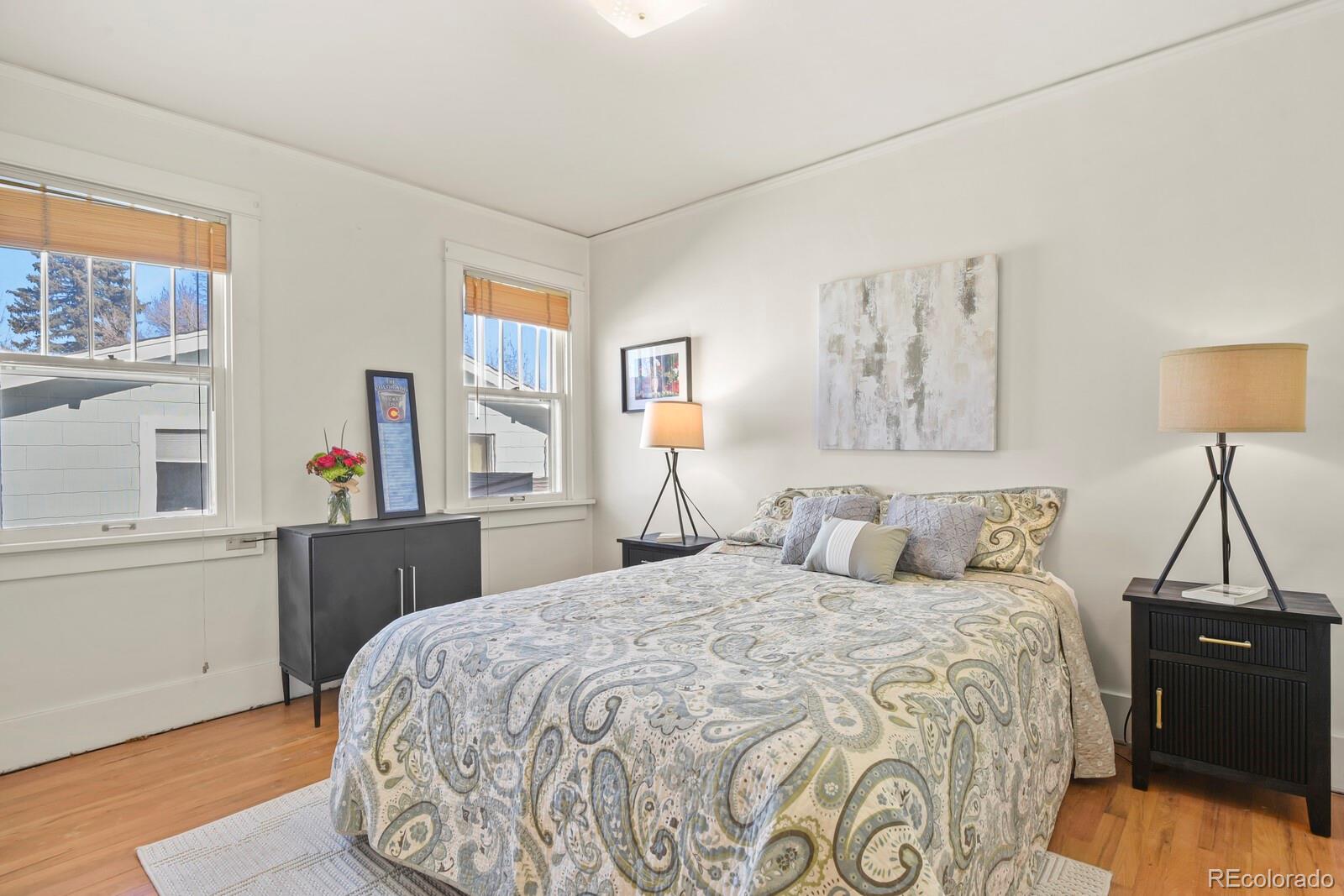 4537 Quitman Street Denver, CO 80212 - Photo 10 of 38 a bedroom with a bed and a chandelier