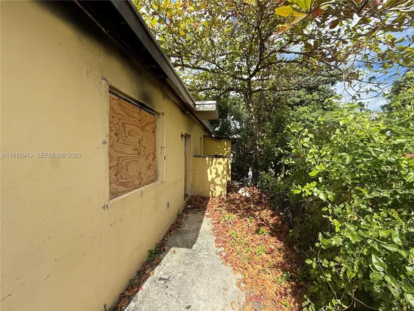 a yellow house with trees in front of it