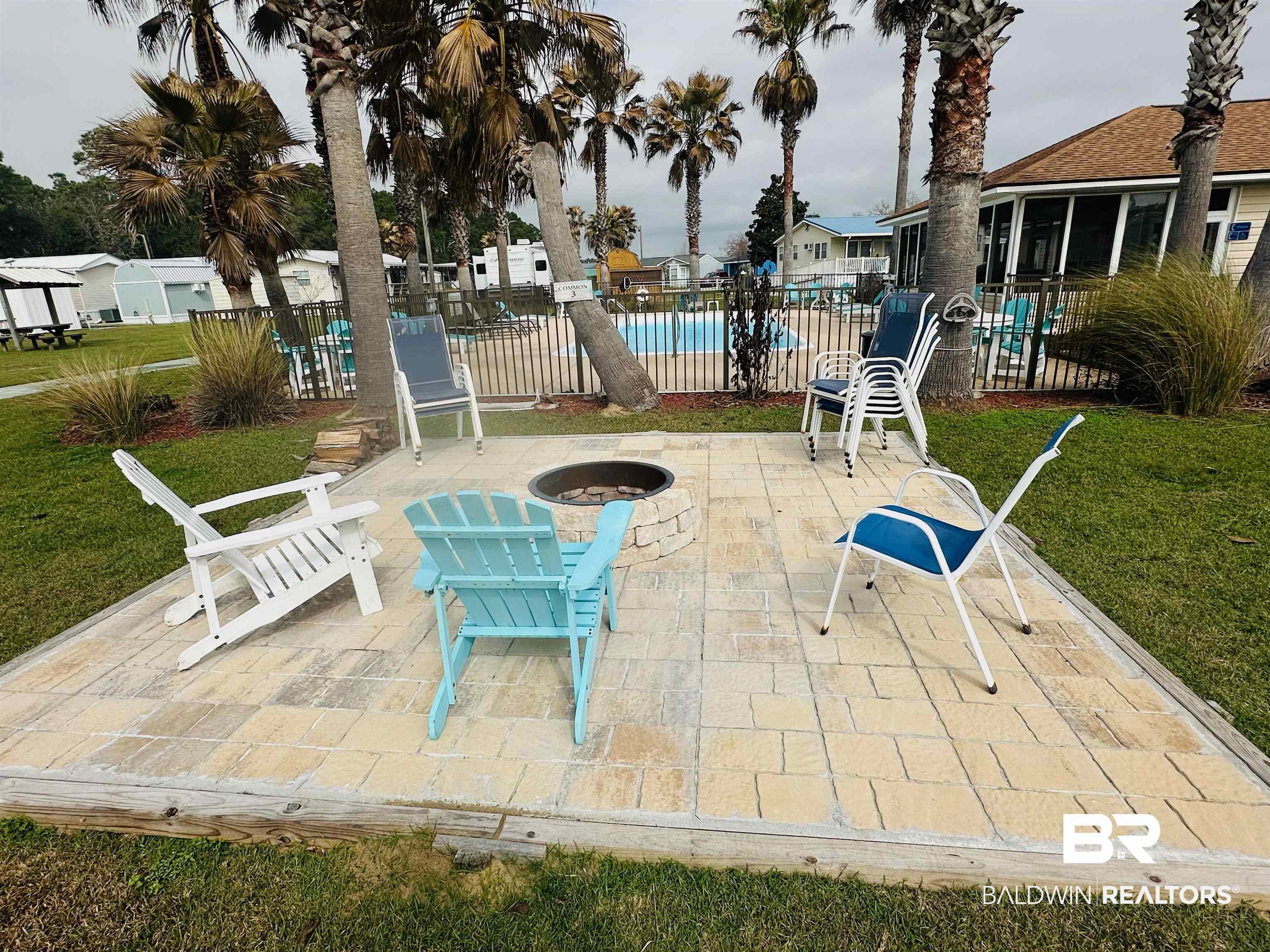 4214 Azalea Street Orange Beach, AL 36561 - Photo 5 of 7 View of patio featuring a community pool and a fire pit