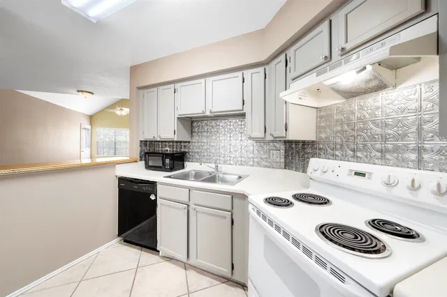 a kitchen with a white cabinets stove and white refrigerator