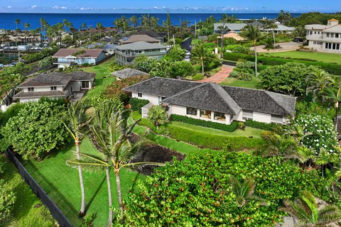an aerial view of a house with a yard