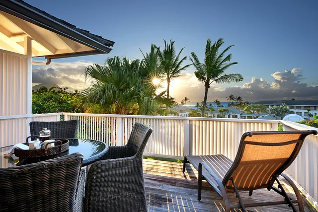 a view of a chair and table on the roof deck