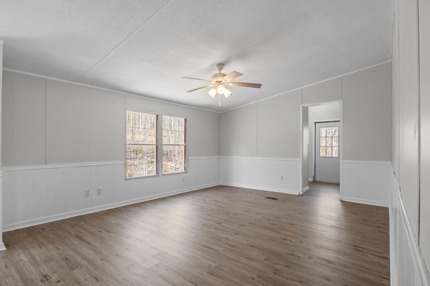 624 Nickletown Road Sugar Tree, TN 38380 - Photo 20 of 45 an empty room with wooden floor and windows