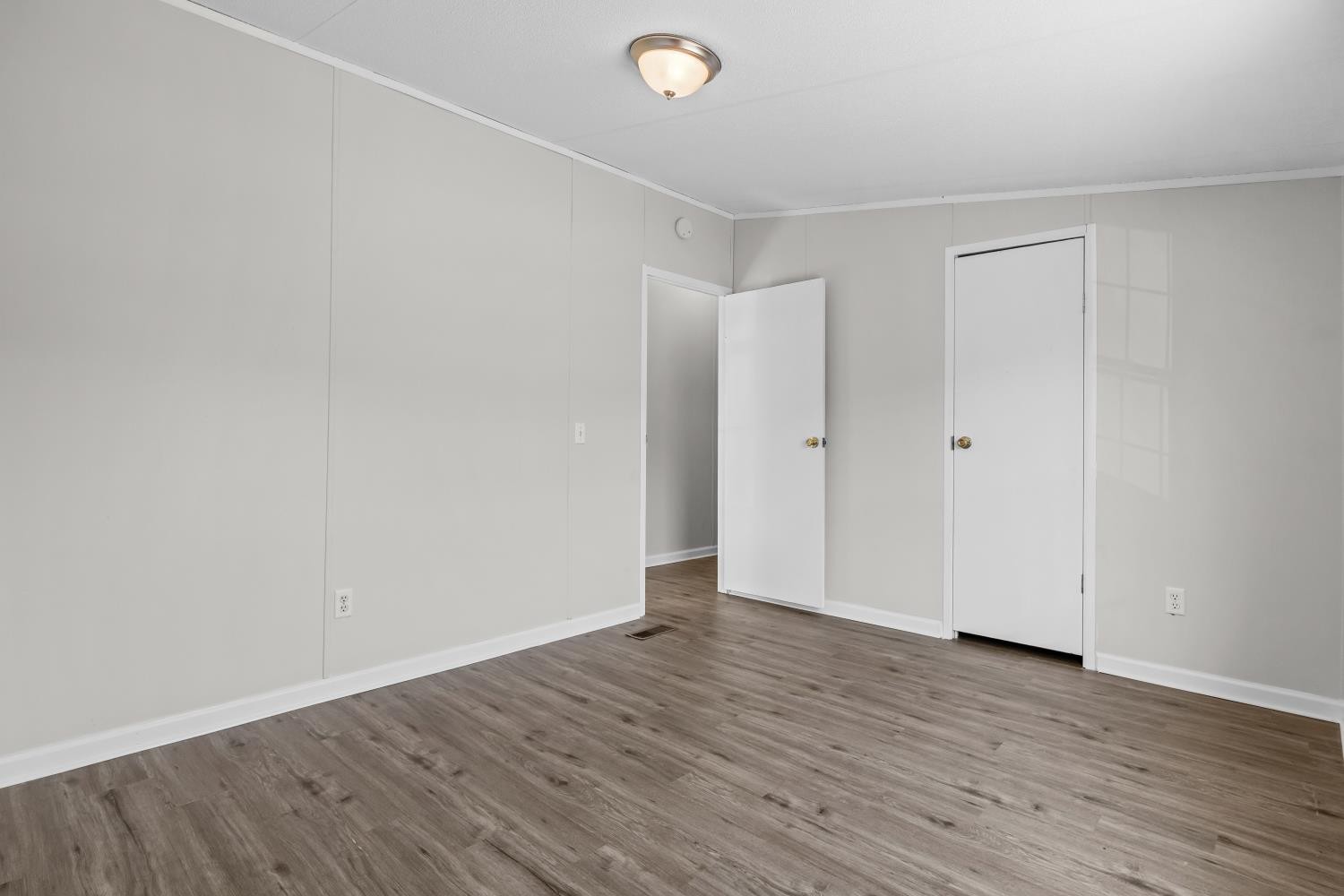 624 Nickletown Road Sugar Tree, TN 38380 - Photo 31 of 45 a view of an empty room with wooden floor
