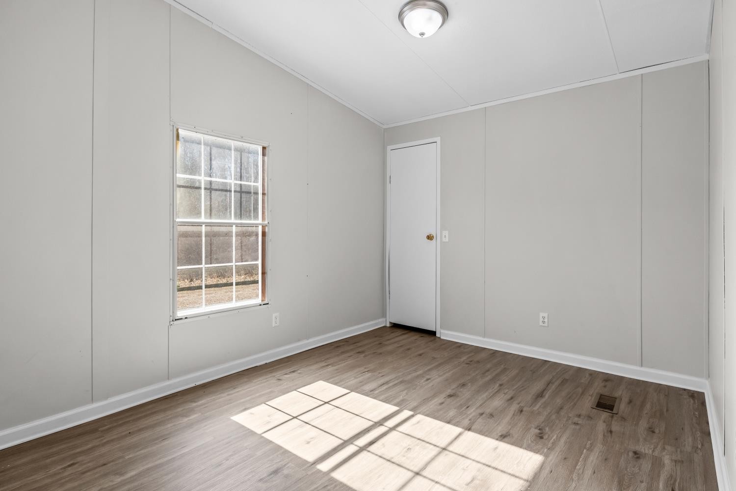 624 Nickletown Road Sugar Tree, TN 38380 - Photo 32 of 45 an empty room with wooden floor and windows