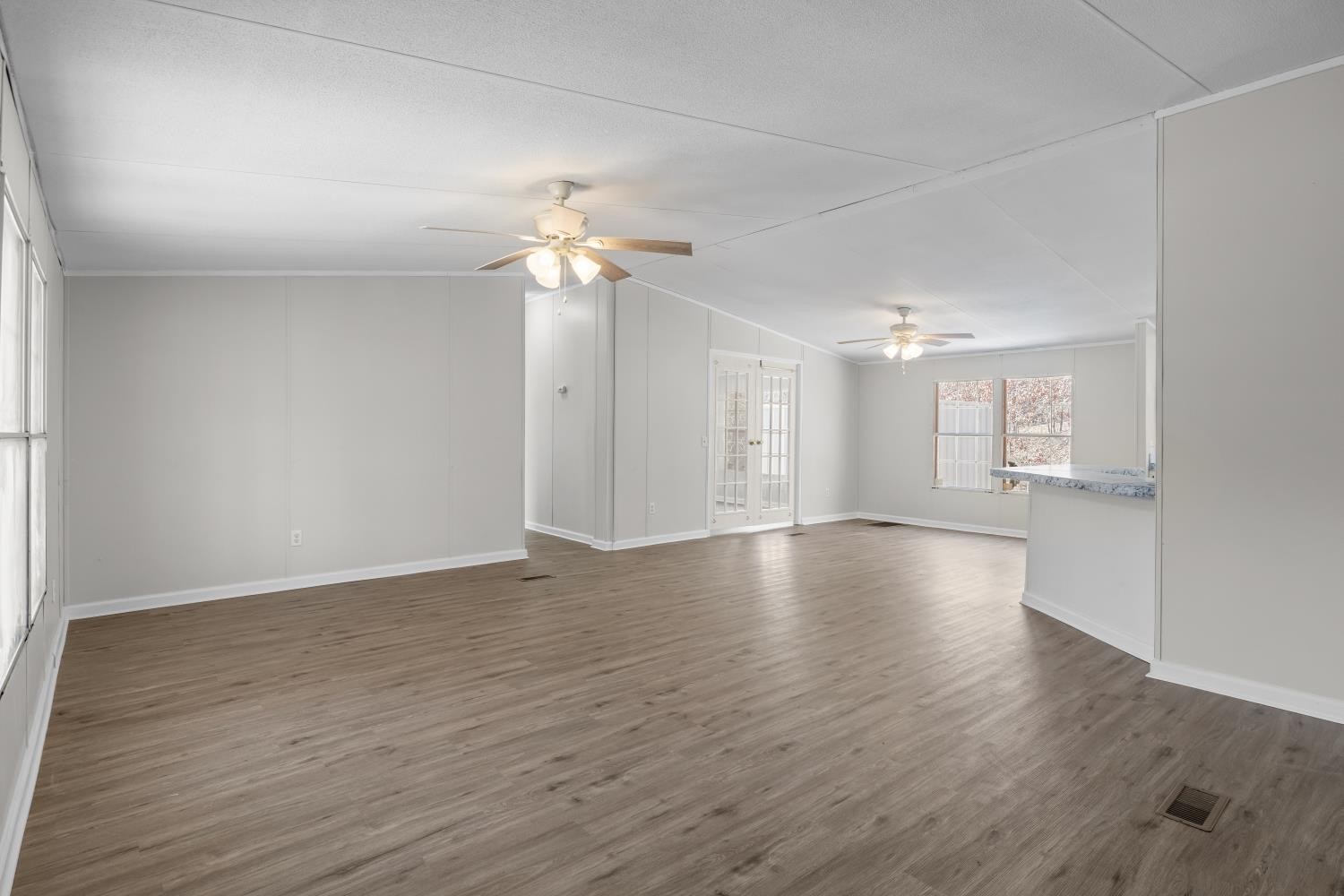 624 Nickletown Road Sugar Tree, TN 38380 - Photo 8 of 45 a view of an empty room with a window and wooden floor