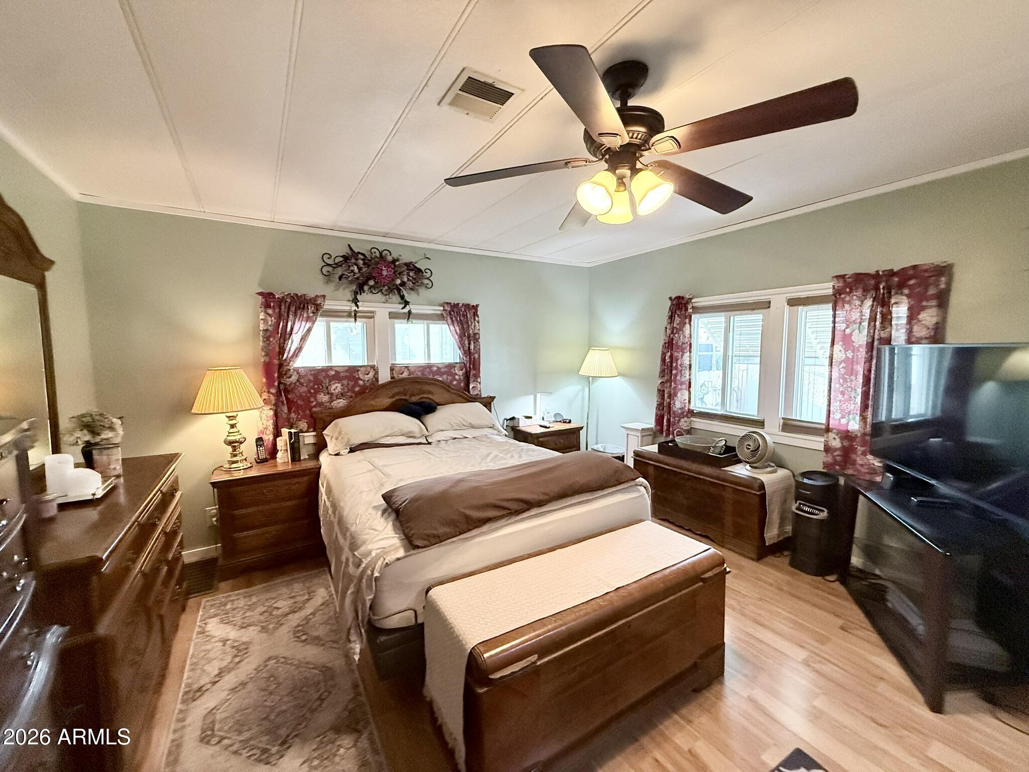 201 South Greenfield Road, Unit 246 Mesa, AZ 85206 - Photo 15 of 42 a bedroom with a bed and a chandelier