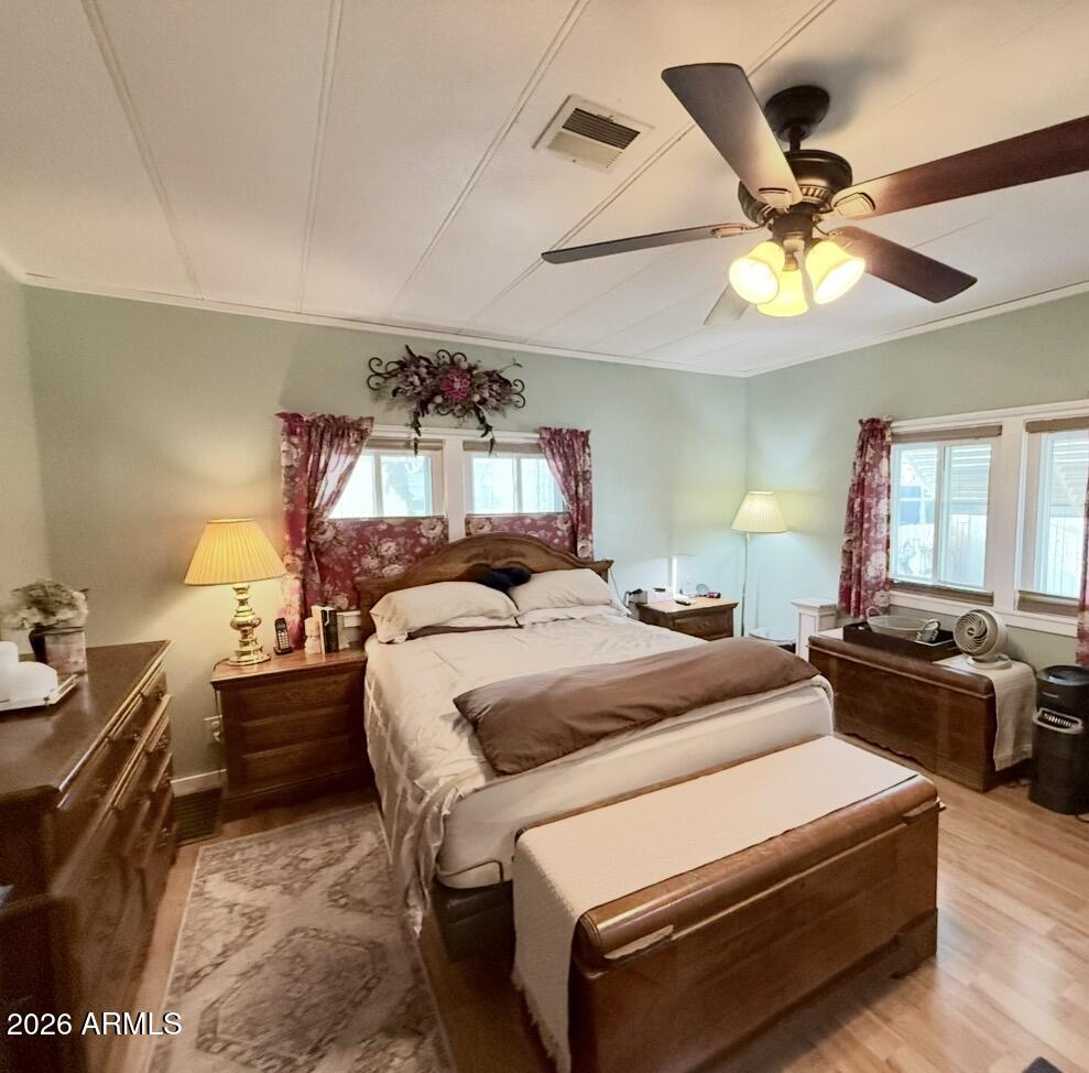 201 South Greenfield Road, Unit 246 Mesa, AZ 85206 - Photo 17 of 42 a bedroom with a bed and a chandelier