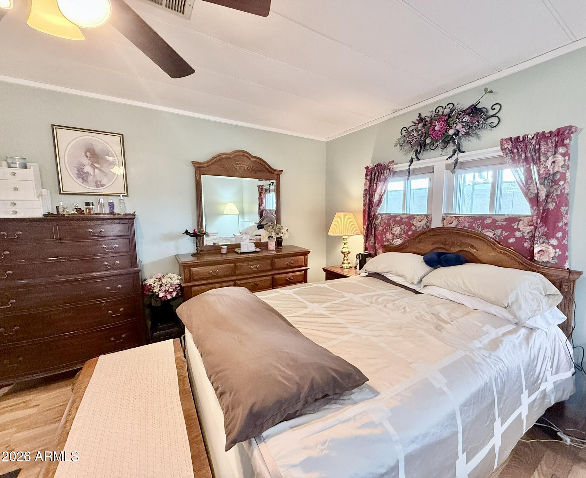 201 South Greenfield Road, Unit 246 Mesa, AZ 85206 - Photo 19 of 42 a bedroom with a bed and a chandelier