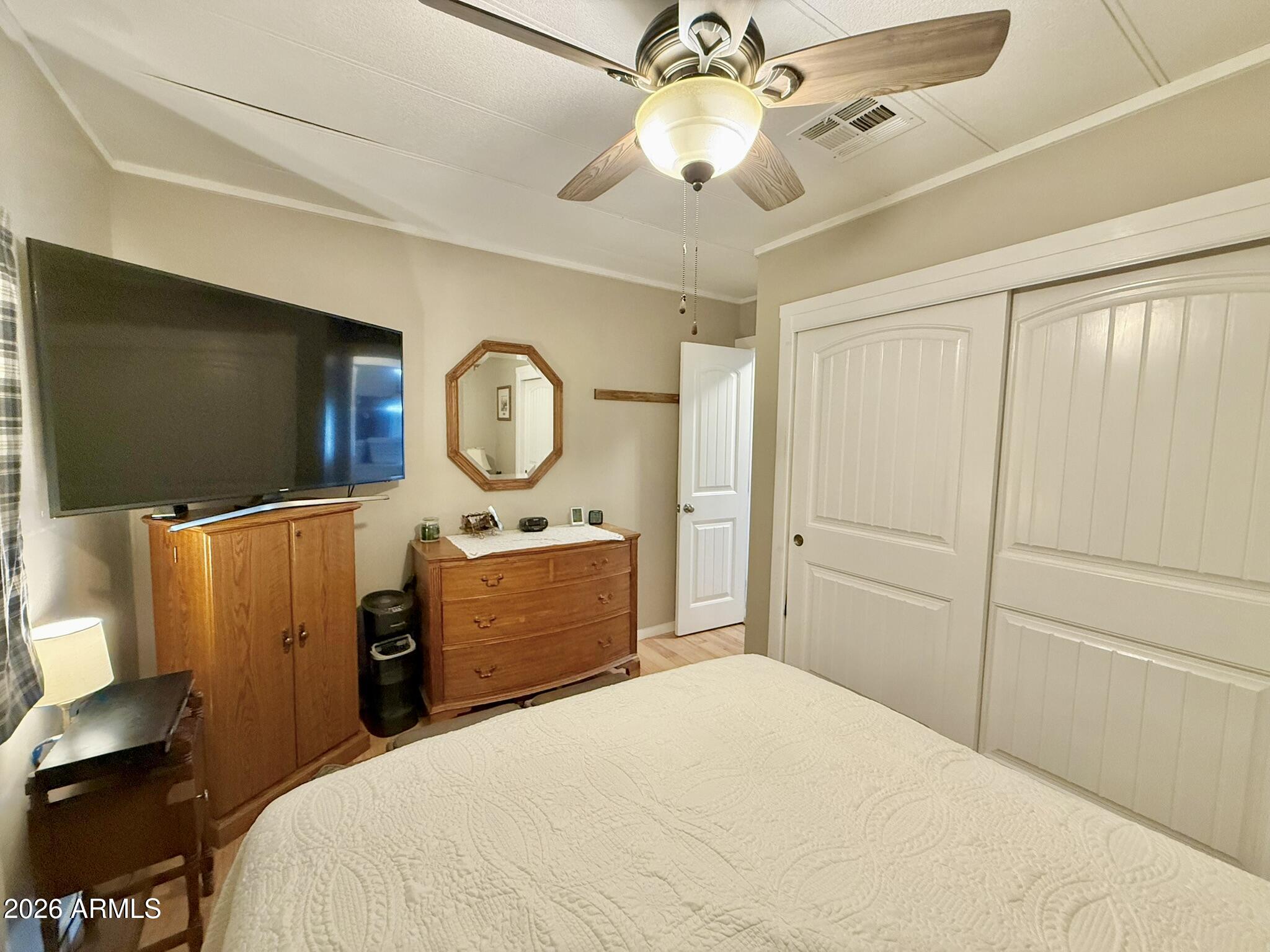 201 South Greenfield Road, Unit 246 Mesa, AZ 85206 - Photo 25 of 42 a bedroom with a bed and a flat screen tv