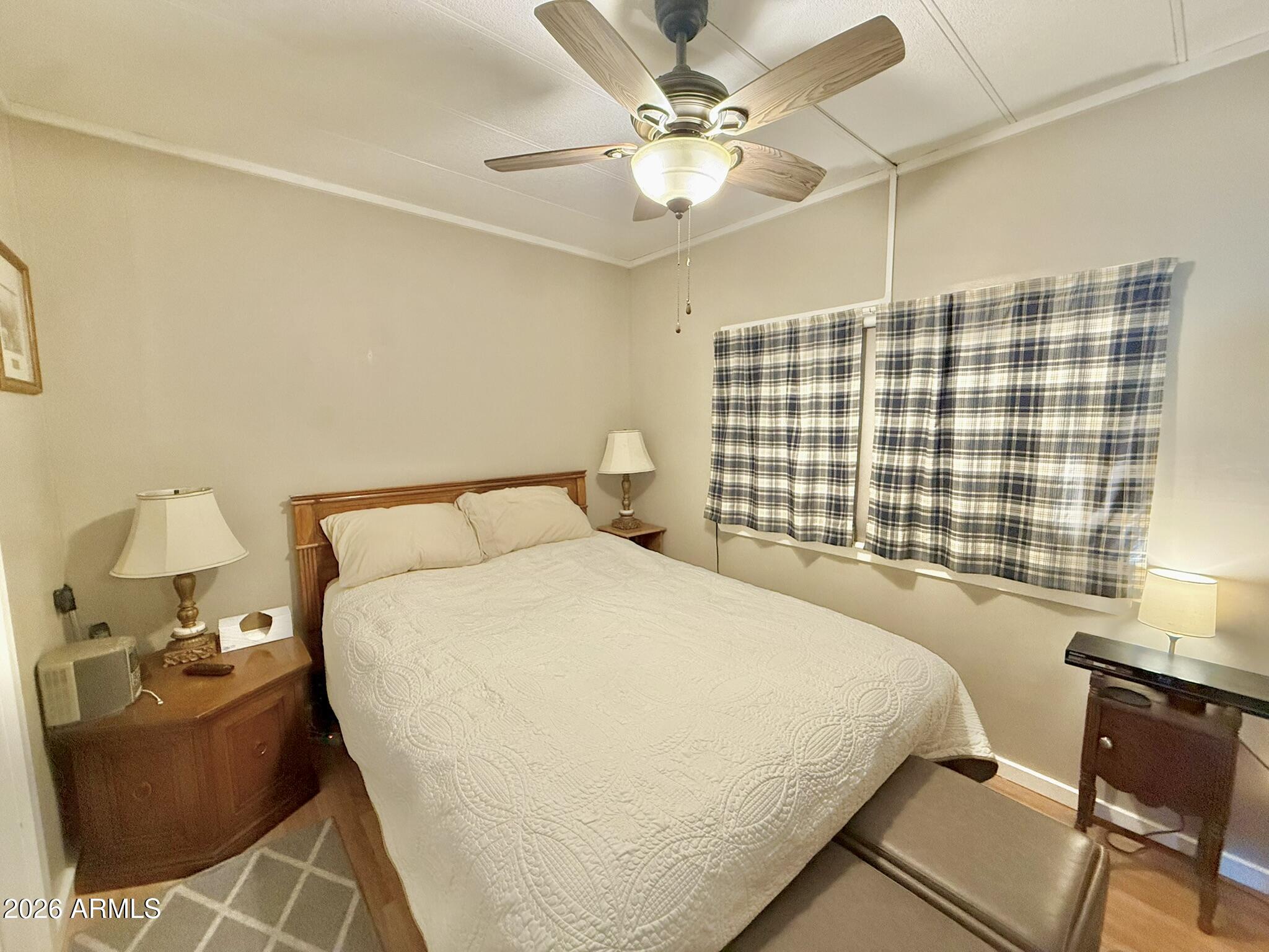 201 South Greenfield Road, Unit 246 Mesa, AZ 85206 - Photo 26 of 42 a bedroom with a bed couch and window