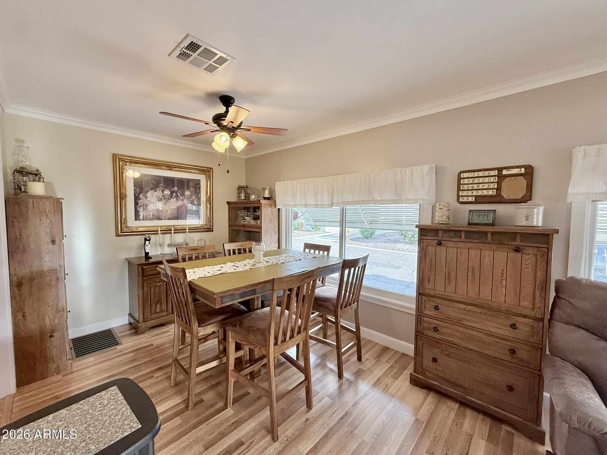 201 South Greenfield Road, Unit 246 Mesa, AZ 85206 - Photo 3 of 42 a view of a dining room with furniture window and wooden floor