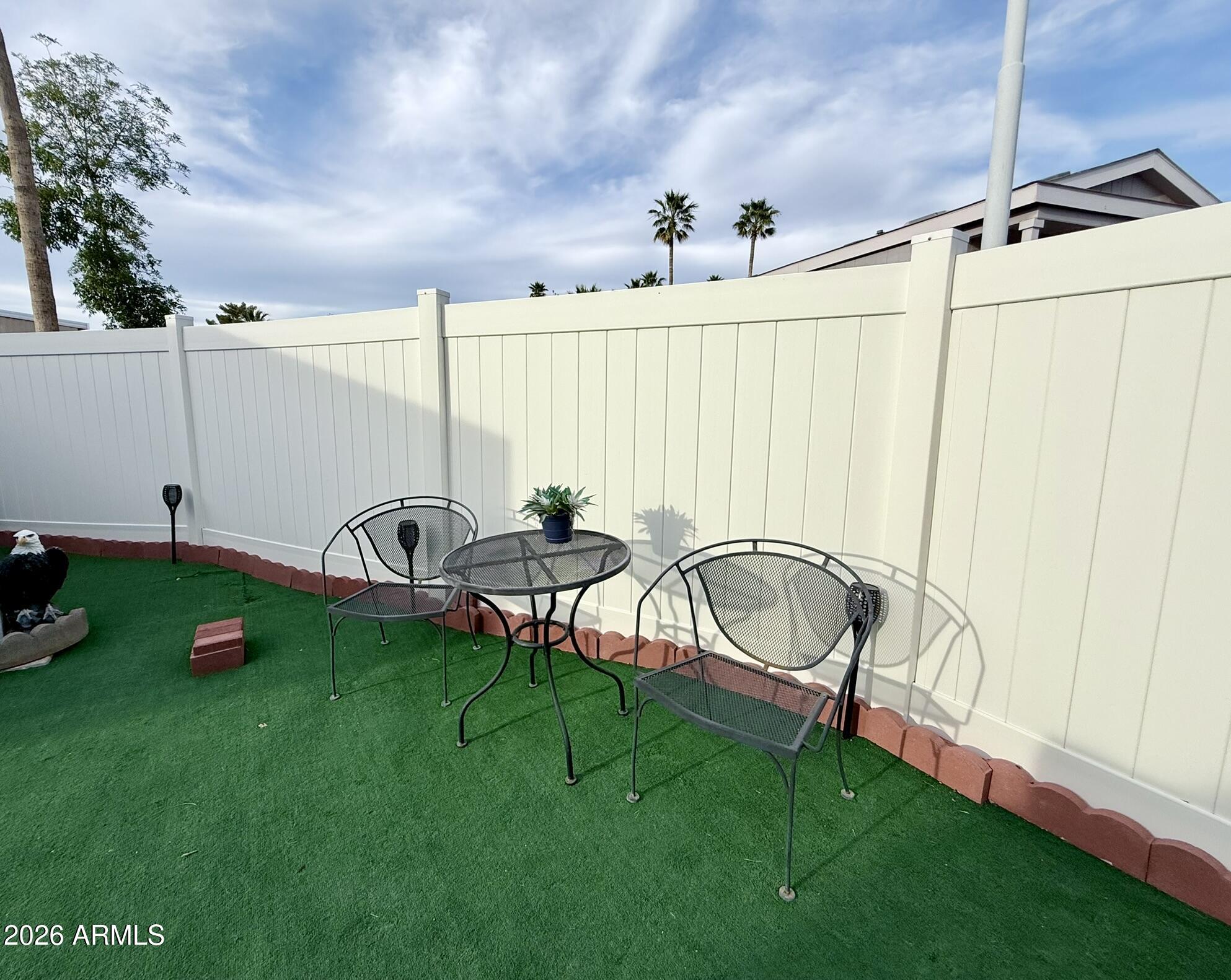 201 South Greenfield Road, Unit 246 Mesa, AZ 85206 - Photo 35 of 42 a view of a table and chairs in the grass
