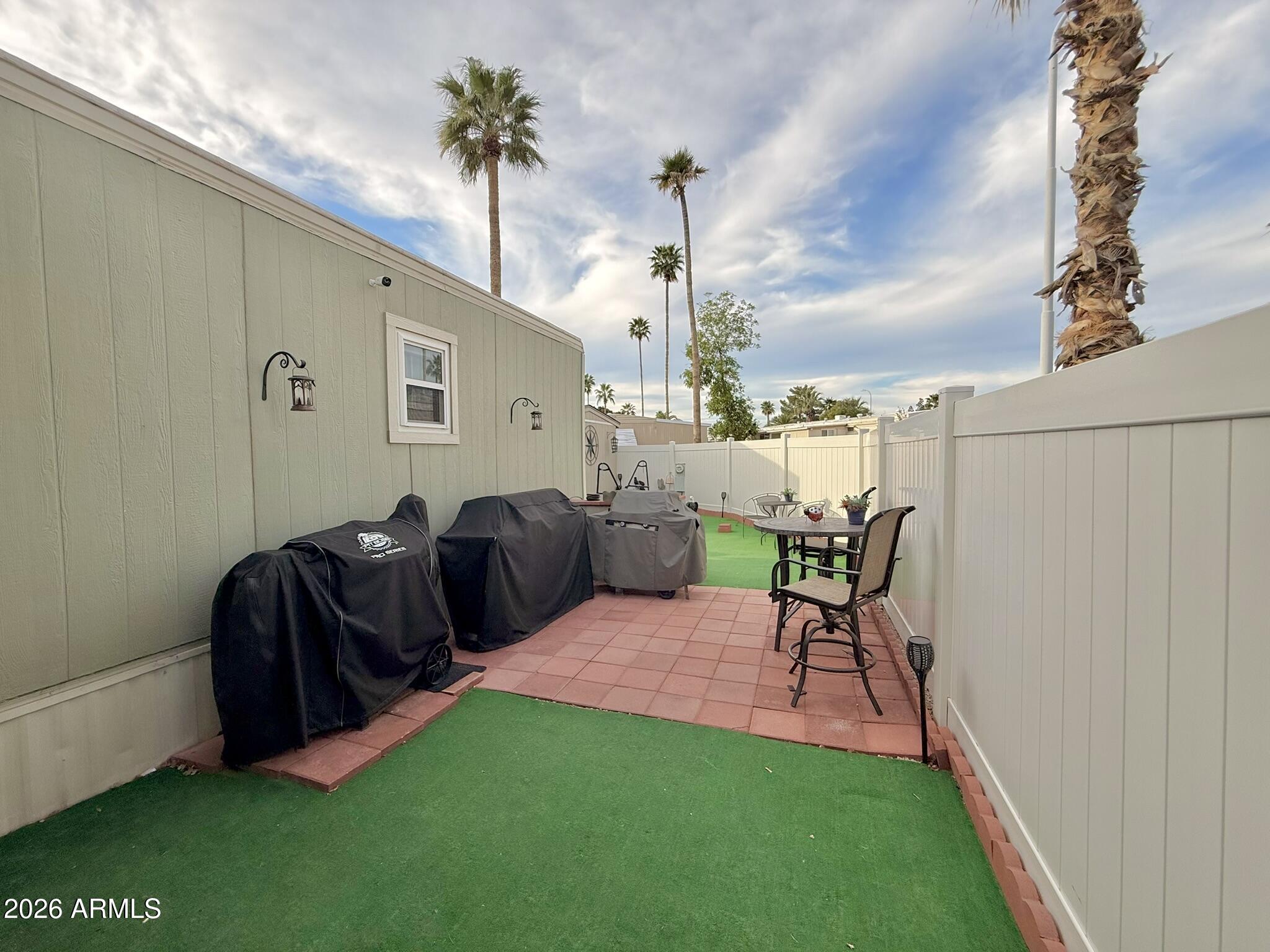 201 South Greenfield Road, Unit 246 Mesa, AZ 85206 - Photo 37 of 42 a balcony with chairs and a potted plant