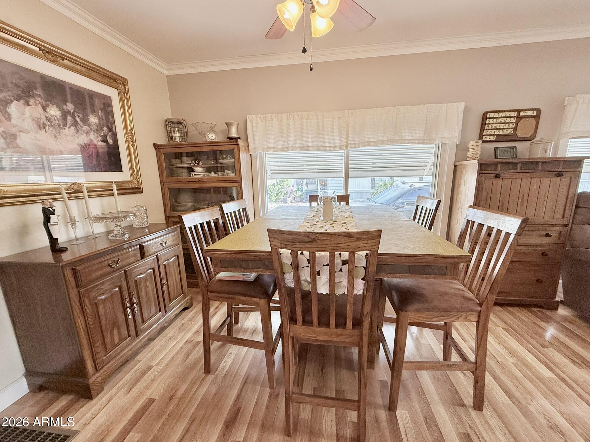 201 South Greenfield Road, Unit 246 Mesa, AZ 85206 - Photo 9 of 42 a view of a dining room with furniture window and wooden floor