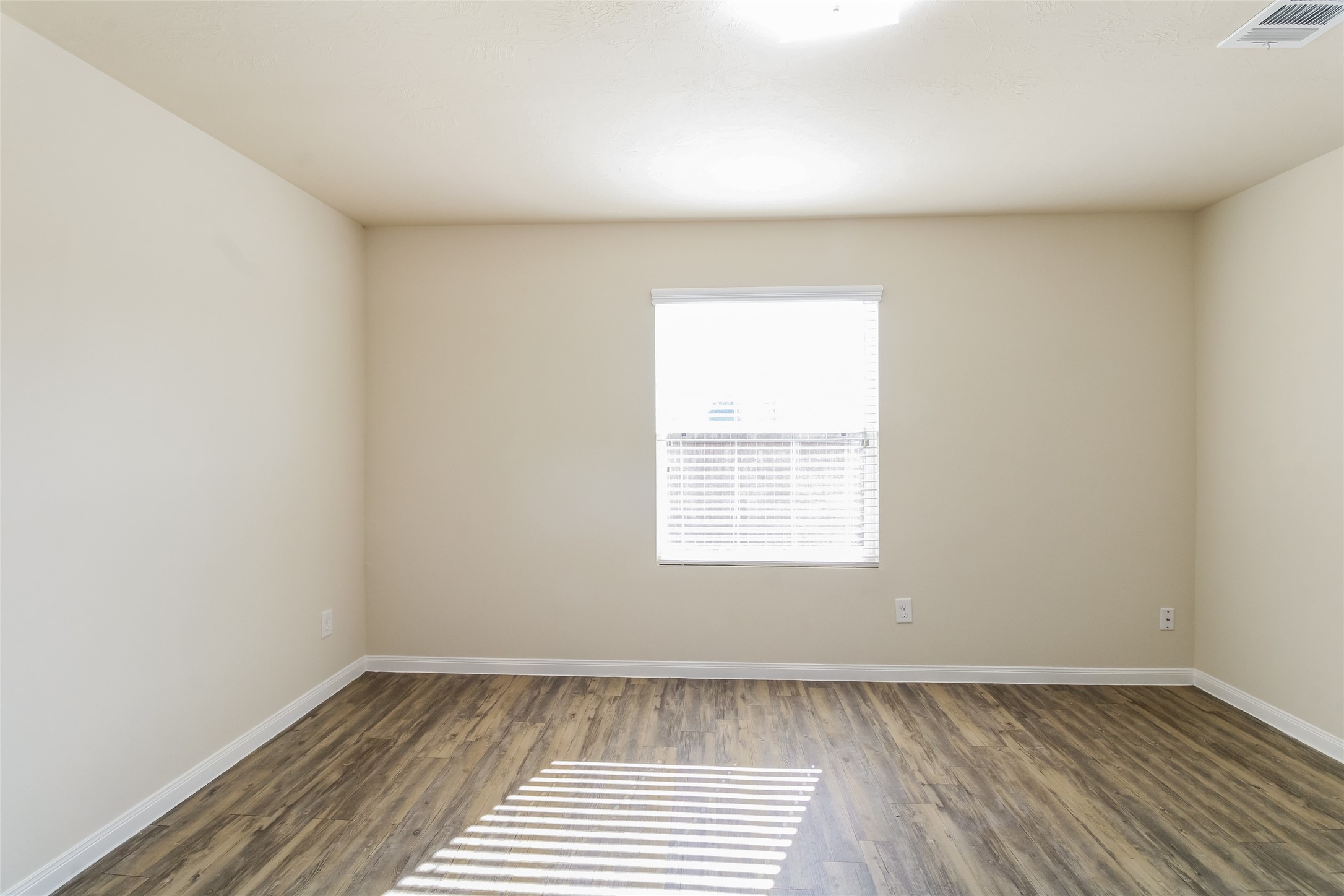 12419 Gemma Lane Houston, TX 77044 - Photo 10 of 15 an empty room with wooden floor and windows