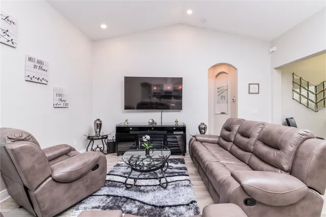 a living room with furniture a rug and a flat screen tv