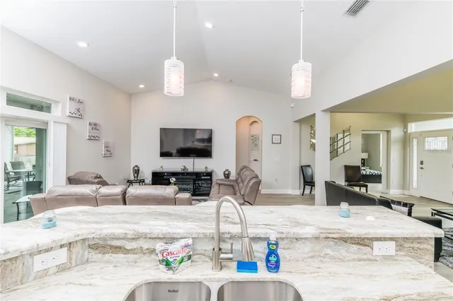a kitchen with counter top space a sink and a chandelier