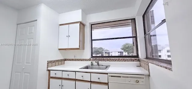 a kitchen with a sink and a window