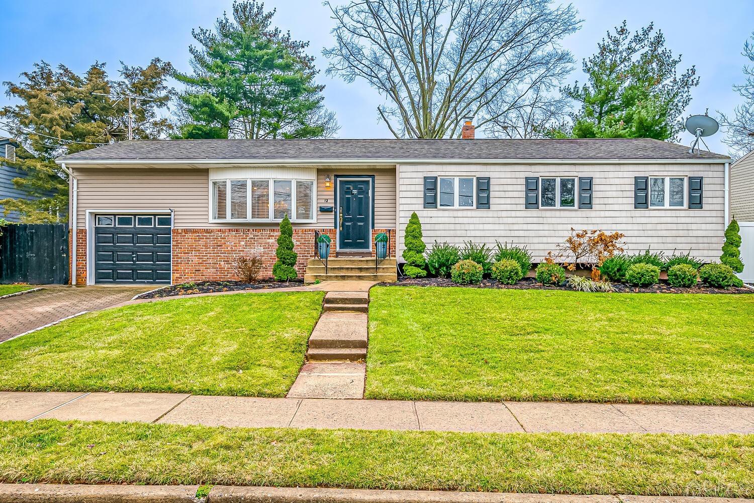 12 Eardley Road Edison, NJ 08817 - Photo 1 of 36 a front view of a house with a garden and yard