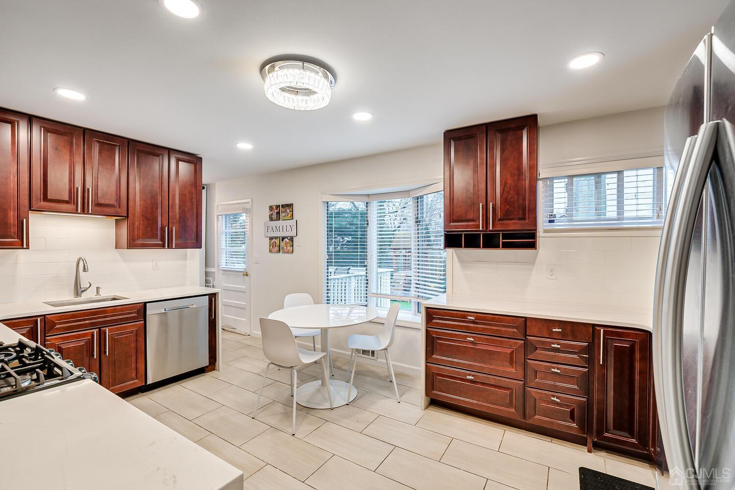 12 Eardley Road Edison, NJ 08817 - Photo 13 of 36 a kitchen with stainless steel appliances granite countertop a stove and cabinets